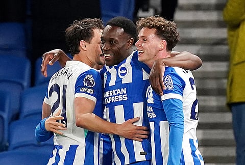 Brighton and Hove Albion's Danny Welbeck, center, celebrates scoring their third goal during the Premier League soccer match between Brighton and Hove Albion and Chelsea, in Brighton, England.