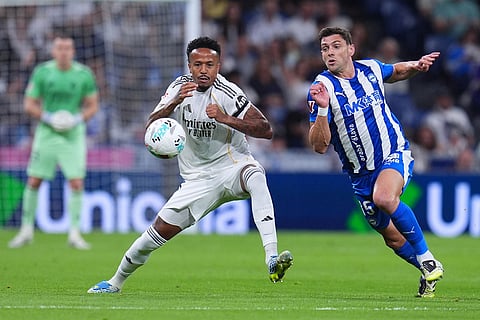 Real Madrid's Eder Militao, left, and Alaves' Lucas Boye fight for the ball during a La Liga soccer match between Real Madrid and Alaves in Madrid, Spain.