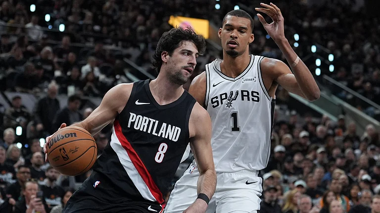Portland Trail Blazers forward Deni Avdija (8) drives around San Antonio Spurs forward Victor Wembanyama (1) during the first half in Game 2 of a first-round. - AP/Eric Gay