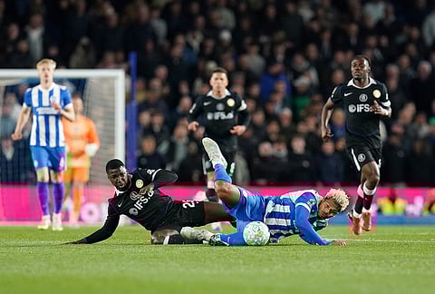 Chelsea's Moises Caicedo, left, and Brighton and Hove Albion's Georginio Rutter battle for the ball during the Premier League soccer match between Brighton and Hove Albion and Chelsea, in Brighton, England. 