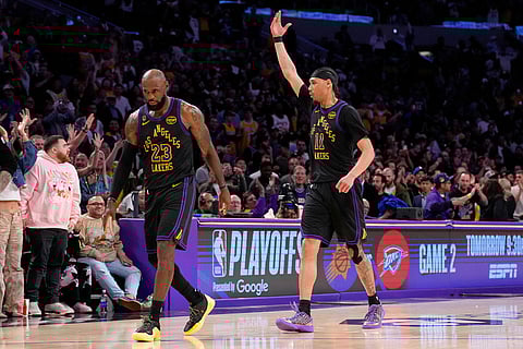 Los Angeles Lakers center Jaxson Hayes, right, as forward LeBron James walks off the court after the Lakers defeated the Houston Rockets in Game 2 of a first-round NBA playoffs basketball series in Los Angeles.
