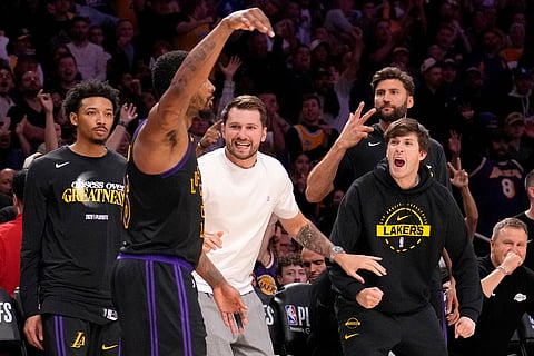 Los Angeles Lakers guard Marcus Smart, second from left, celebrates along with team members on the bench after scoring during the second half in Game 2 of a first-round NBA playoffs basketball series against the Houston Rockets in Los Angeles.