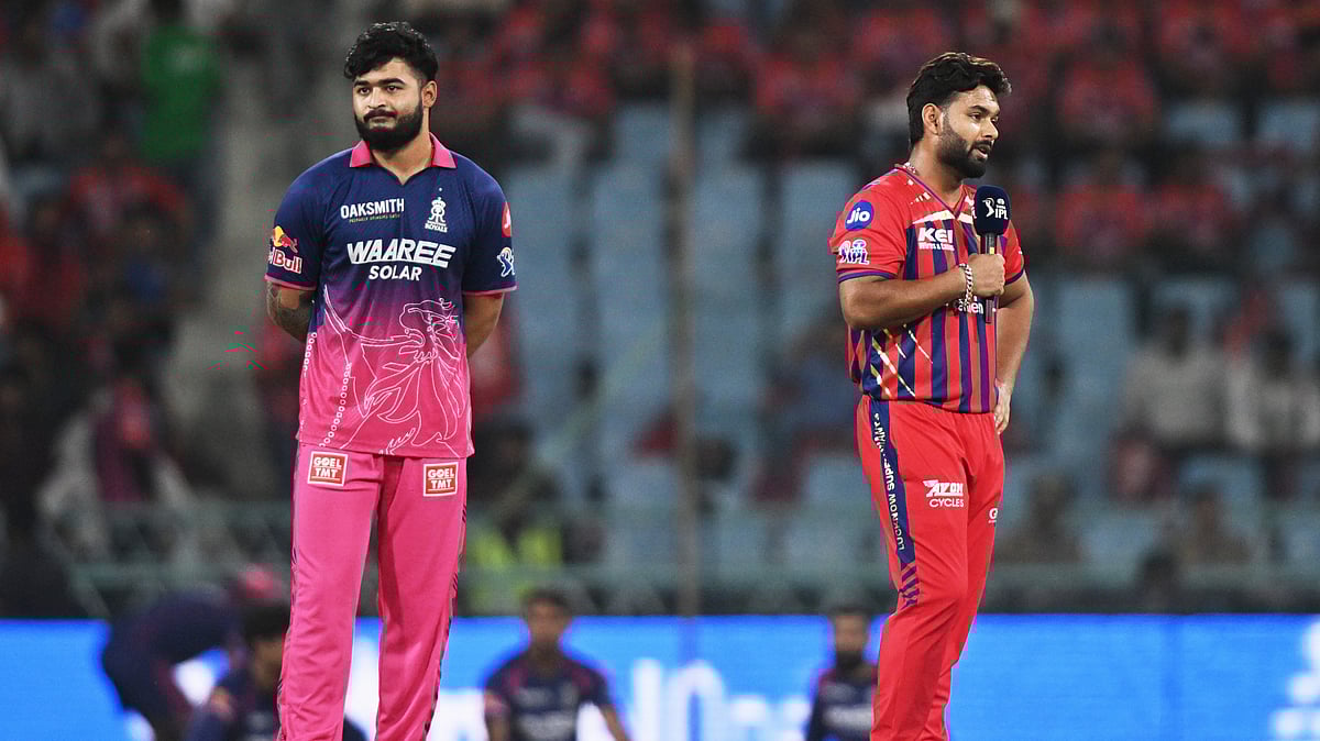 Rajasthan Royals' captain Riyan Parag, left, looks on as Lucknow Super Giants' captain Rishabh Pant talks to a commentator after losing the coin toss of the Indian Premier League cricket match between Lucknow Super Giants and Rajasthan Royals in Lucknow, India, Wednesday, April 22, 2026 - (AP Photo)