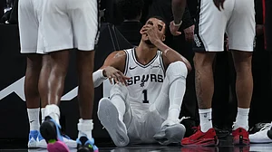 AP/Eric Gay : San Antonio Spurs forward Victor Wembanyama (1) sits on the court after a hard fall during the first half in Game 2 of a first-round NBA playoffs.