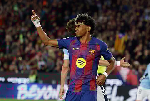 Barcelona's Lamine Yamal celebrates after scoring the opening goal during the Spanish La Liga soccer match between Barcelona and Celta Vigo in Barcelona, Spain.