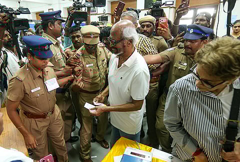 Actor Rajinikanth arrives to cast his vote in the Tamil Nadu Assembly elections, at a polling station in Chennai.