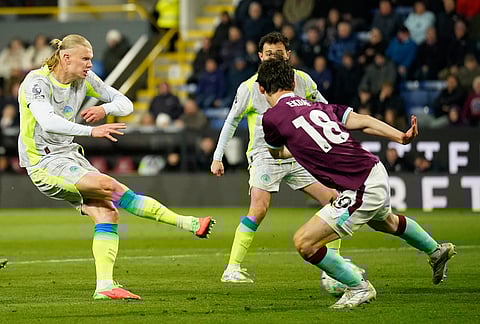 Manchester City's Erling Haaland shoots during the Premier League soccer match between Burnley and Manchester City in Burnley, England.
