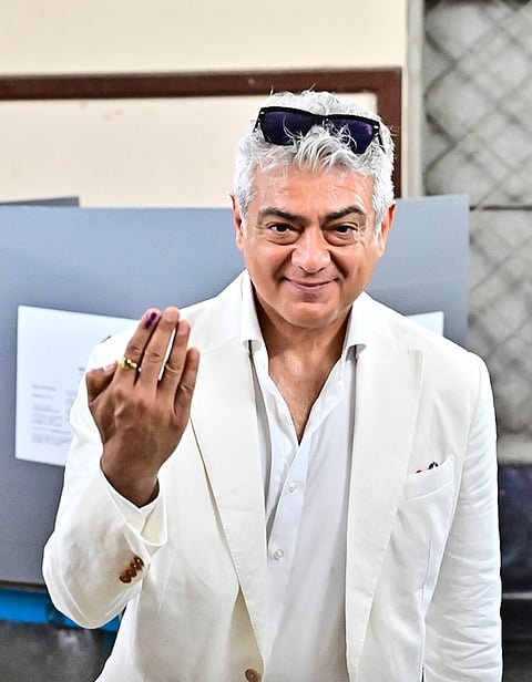 Actor Ajith Kumar shows his ink-marked finger after casting a vote in the Tamil Nadu Assembly elections, at a polling station in Chennai.