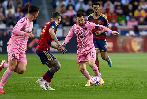 Inter Miami midfielder Lionel Messi (10) controls the ball as he works through the defense of Real Salt Lake defender Alexandros Katranis, center left, during an MLS soccer match, in Sandy, Utah.
