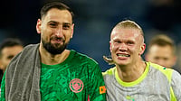 AP/Dave Thompson : Manchester City's goalkeeper Gianluigi Donnarumma, left, and Erling Haaland walk off the pitch.