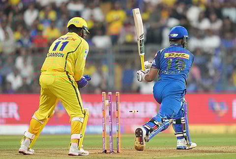 Mumbai Indians' Naman Dhir bowled out by Chennai Super Kings' Akeal Hosein during the Indian Premier League cricket match between Mumbai Indians and Chennai Super Kings in Mumbai.