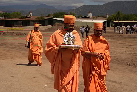BAPS Shri Swaminarayan Mandir temple Hindu monks walk after performing a Puja ceremony, a traditional blessing ritual for the groundbreaking ceremony for the official home field for the Los Angeles Knight Riders for 2026, and the future venue of the LA 2028 Olympics Fairgrounds Cricket Stadium at the Pomona Fairplex in Pomona, California.