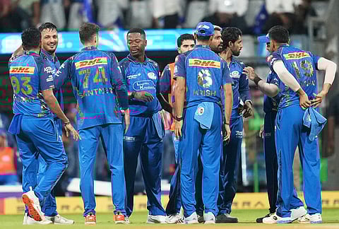 Mumbai Indians' Allah Ghazanfar, second left, celebrates with teammates the wicket of Chennai Super Kings' captain Ruturaj Gaikwad during the Indian Premier League cricket match between Mumbai Indians and Chennai Super Kings in Mumbai.