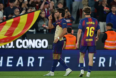 Barcelona's Ferran Torres, left, celebrates after scoring a goal that was later disallowed by a VAR decision during the Spanish La Liga soccer match between Barcelona and Celta Vigo in Barcelona, Spain.
