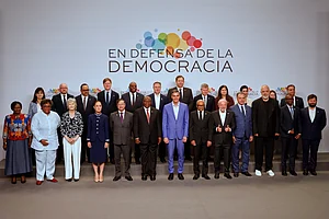 Joan Monfort : Spain's Prime Minister Pedro Sanchez, center, poses with attendees at the Meeting in Defence of Democracy summit in Barcelona, Spain, Saturday, April 18, 2026.