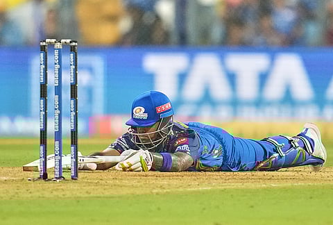 Mumbai Indians' Suryakumar Yadav dives to compete a run during the Indian Premier League cricket match between Mumbai Indians and Chennai Super Kings in Mumbai.