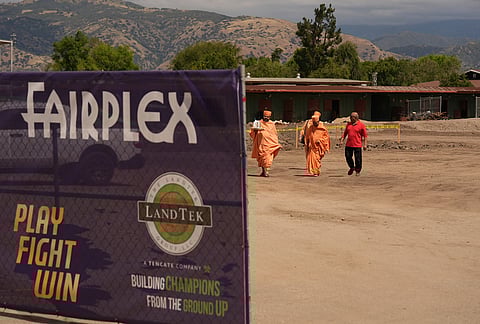 BAPS Shri Swaminarayan Mandir temple Hindu monks walk after performing a Puja ceremony, a traditional blessing ritual for the groundbreaking ceremony for the official home field for the Los Angeles Knight Riders for 2026, and the future venue of the LA 2028 Olympics Fairgrounds Cricket Stadium at the Pomona Fairplex in Pomona, California.