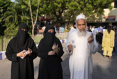 Voters show their ink-marked fingers after casting their vote during Tamil Nadu Assembly elections at a polling booth in Egmore, Tamil Nadu.