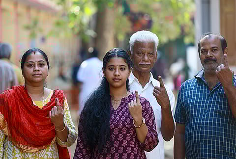 Voters show their ink-marked fingers after casting their votes, at a polling station, for the Tamil Nadu Assembly elections, at Nagercoil, in Kanyakumari district.