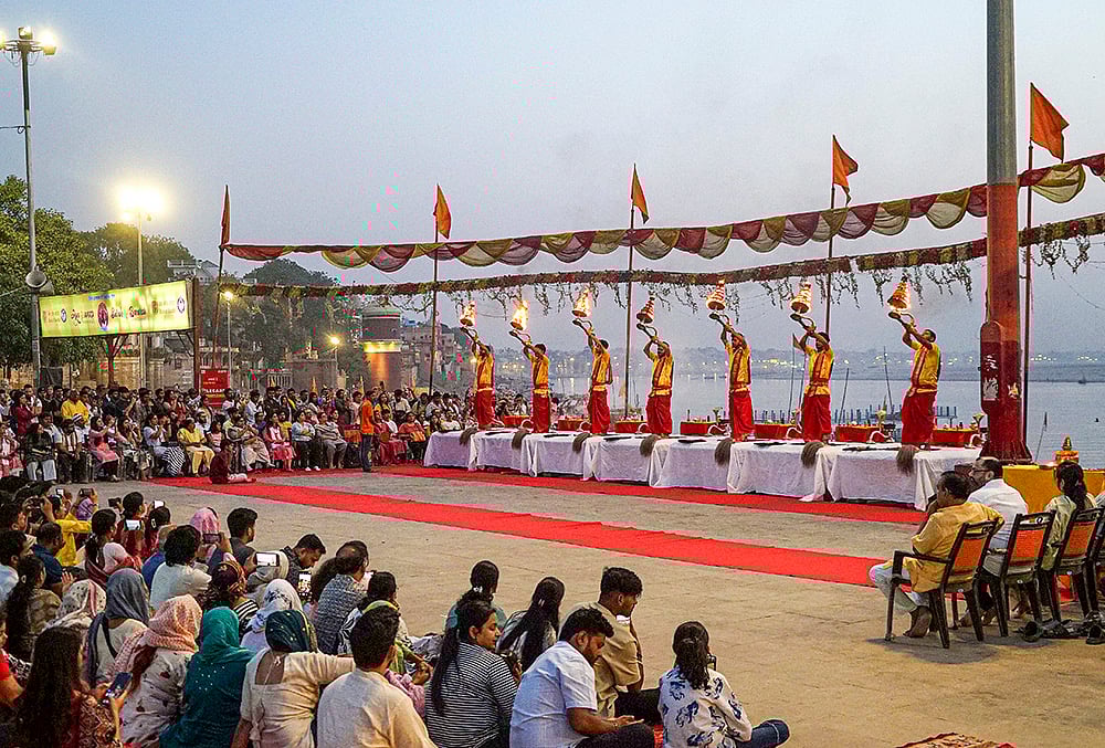 Priests perform ‘aarti’ during the ‘Ganga Saptami’ festival, at Assi Ghat in Varanasi. - | Photo: PTI