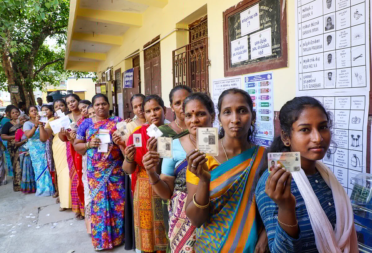 Women show their identity cards as they queue to vote at a polling station during the Tamil Nadu Assembly elections, in Chennai, Thursday, April 23, 2026. - PTI