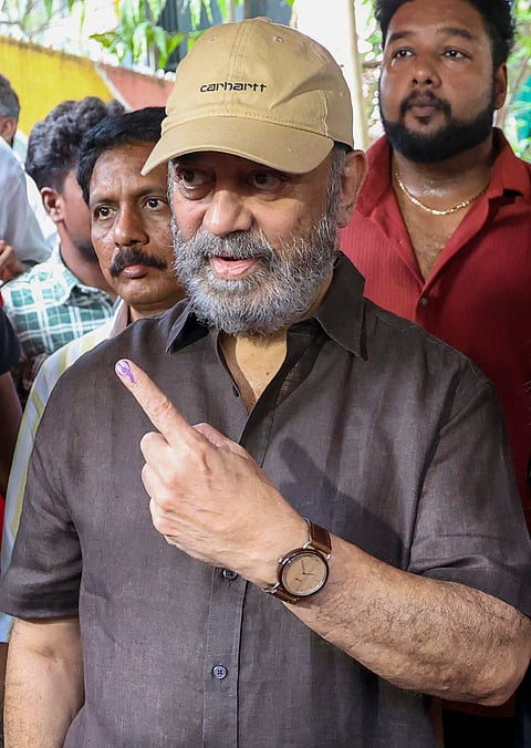 Actor Kamal Haasan shows his ink-marked finger after casting a vote in the Tamil Nadu Assembly elections, at a polling station in Chennai.