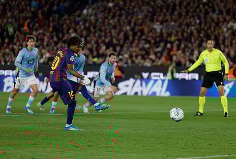 Barcelona's Lamine Yamal scores the opening goal by a penalty during the Spanish La Liga soccer match between Barcelona and Celta Vigo in Barcelona, Spain.