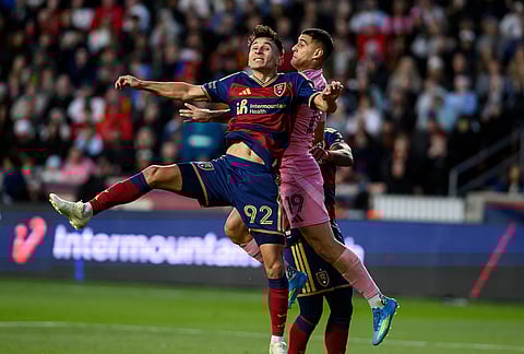Real Salt Lake midfielder Noel Caliskan (92) and Inter Miami forward Germán Berterame (19) go up to head the ball during an MLS soccer match, in Sandy, Utah. 