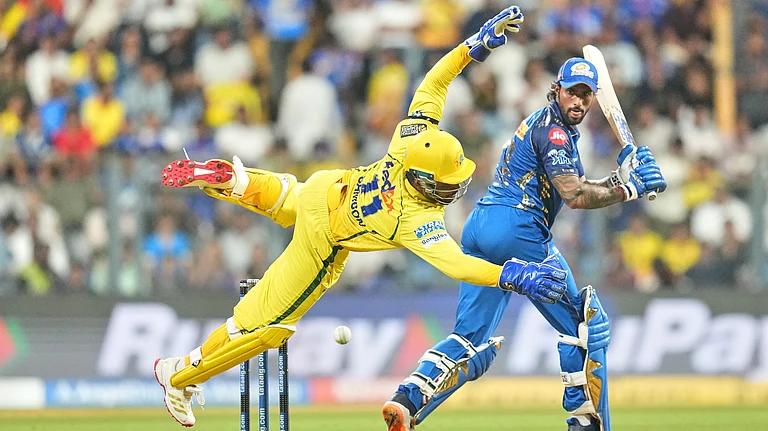 Chennai Super Kings' Sanju Samson dives to field the ball as Mumbai Indians' Tilak Varma looks back after playing a shot during the Indian Premier League cricket match between Mumbai Indians and Chennai Super Kings in Mumbai, India, Thursday, April 23, 2026 - (AP Photo/ Rafiq Maqbool)