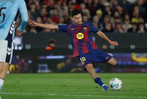 Barcelona's Roony Bardghji shoots the ball during the Spanish La Liga soccer match between Barcelona and Celta Vigo in Barcelona, Spain.