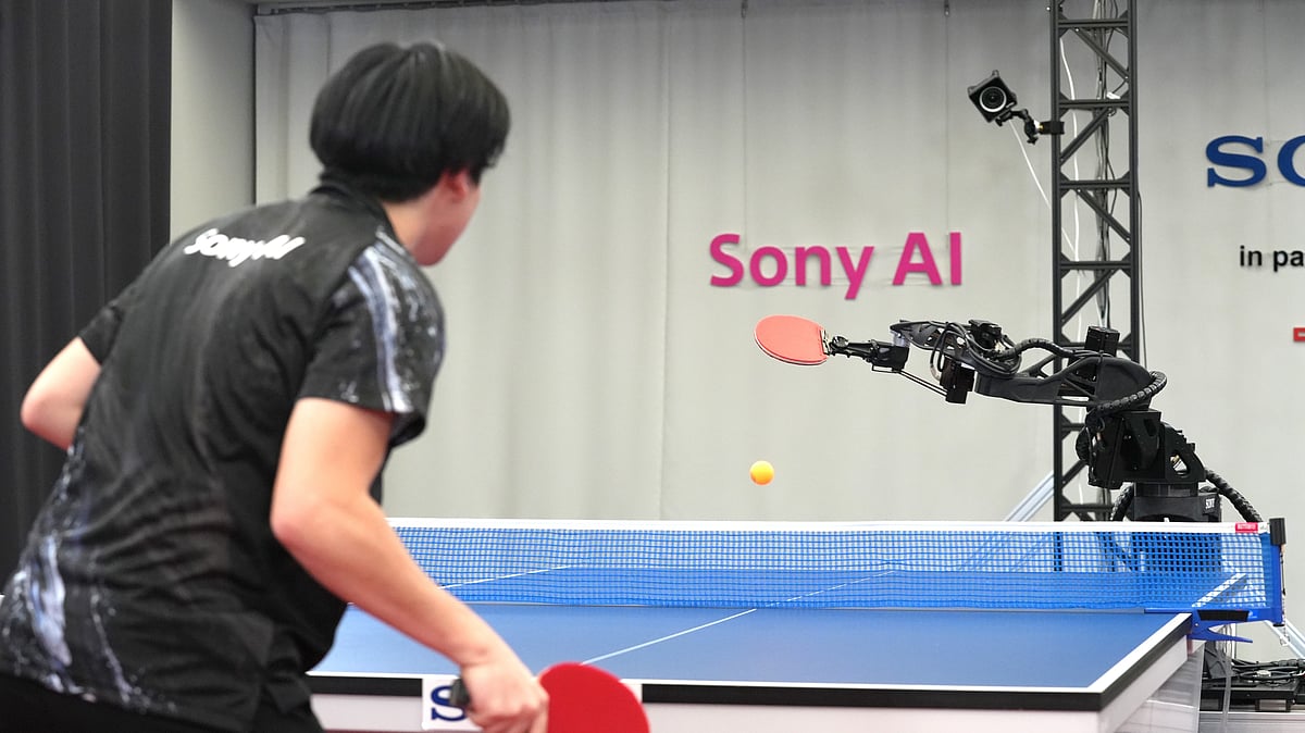 A table tennis robot built by Sony maneuvers to hit the ball back to its human opponent, Akito Saeki, during a match in Tokyo, Dec. 2025. - (Sony AI via AP)