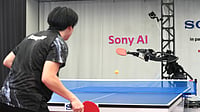 (Sony AI via AP) : A table tennis robot built by Sony maneuvers to hit the ball back to its human opponent, Akito Saeki, during a match in Tokyo, Dec. 2025.