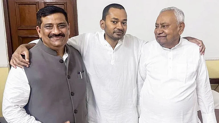 Bihar Chief Minister Nitish Kumar, right, with JD(U) National Working President Sanjay Jha, left, and Nitish Kumar's son Nishant Kumar after he joins the Janata Dal (United) JD(U), in Patna, Bihar. - | Photo: PTI