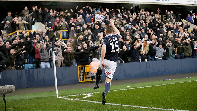 Millwall's Alex Pearce celebrates after scoring a goal during the English FA Cup quarterfinal between Millwall and Brighton & Hove Albion at The Den in London, Sunday March 17, 2018. - | Photo: AP/Tim Ireland