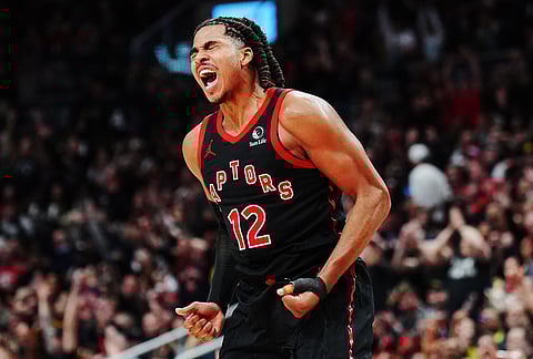 Toronto Raptors' Collin Murray-Boyles (12) celebrates a basket against the Cleveland Cavaliers during the second half of an NBA playoff basketball game in Toronto.