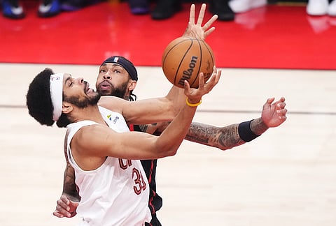 Cleveland Cavaliers' Jarrett Allen (31) and Toronto Raptors' Brandon Ingram (3) battle for the ball during the first half of an NBA playoff basketball game in Toronto.