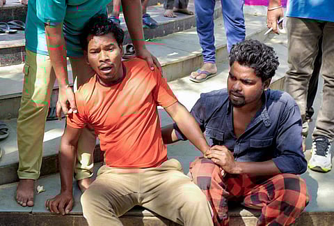 Family members of security guard Birsa Munda react after he was allegedly murdered by unidentified miscreants at Jagannathpur temple, in Ranchi.