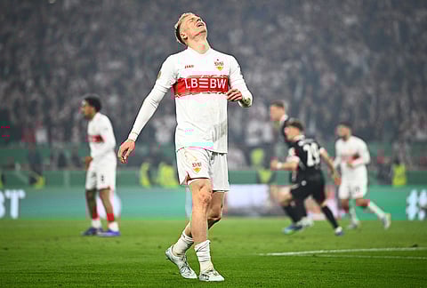 Stuttgart's Chris Fuehrich reacts after missing a scoring chance during a German Cup semifinal soccer match between VfB Stuttgart and SC Freiburg, in Stuttgart, Germany.