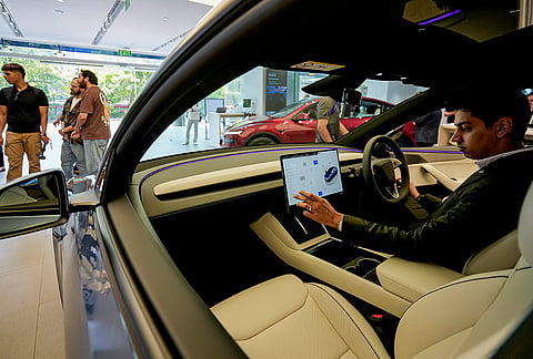 A visitor explores the interior of Tesla's Model Y L at the Tesla Experience Centre, Aerocity, in New Delhi.