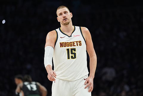 Denver Nuggets center Nikola Jokic (15) walks across the court during the second half in Game 3 of a first-round NBA basketball playoff series against the Minnesota Timberwolves in Minneapolis.