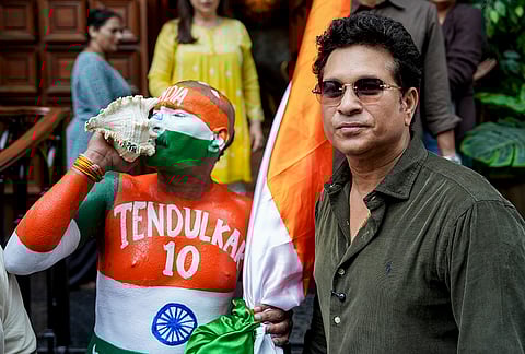 Cricketer Sachin Tendulkar with his fan Sudhir during his birthday celebration, at his residence, in Mumbai.