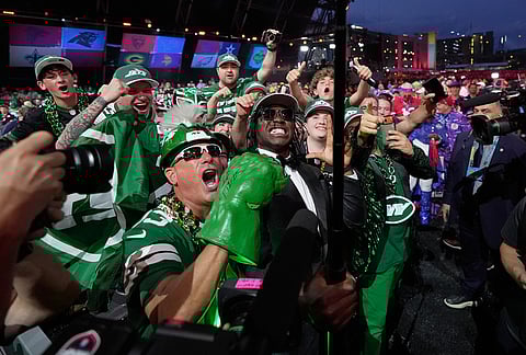 Texas Tech linebacker David Bailey poses with fans after being chosen by the New York Jets with the second overall pick during the first round of the NFL football draft, in Pittsburgh.