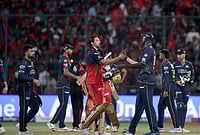 | Photo: AP : Gujarat Titans' Jason Holder congratulates Bengaluru's Tim David after Royal Challengers Bengaluru won against Gujarat Titans during the Indian Premier League cricket match in Bengaluru.