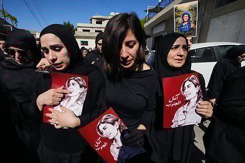 Article:  Mourners hold posters that show portraits of Lebanese journalist Amal Khalil, who was killed Wednesday in an Israeli airstrike, during her funeral procession in the village of Baysariyeh in southern Lebanon on Thursday, April 23, 2026.
