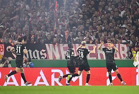 Freiburg's Maximilian Eggestein, right, celebrates after scoring a goal during a German Cup semifinal soccer match between VfB Stuttgart and SC Freiburg, in Stuttgart, Germany. 