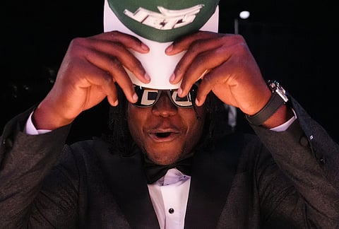 Texas Tech linebacker David Bailey puts on a hat after being chosen by the New York Jets with the second overall pick during the first round of the NFL football draft, in Pittsburgh.