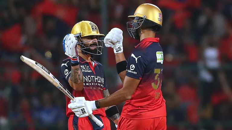 Royal Challengers Bengaluru's Virat Kohli celebrates his fifty runs with batting partner Devdutt Padikkal during the Indian Premier League cricket match between Royal Challengers Bengaluru and Gujarat Titans in Bengaluru, - AP Photo