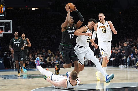 Minnesota Timberwolves guard Anthony Edwards (5) shoots over Denver Nuggets guard Jamal Murray (27) during the second half in Game 3 of a first-round NBA basketball playoff series, in Minneapolis. 
