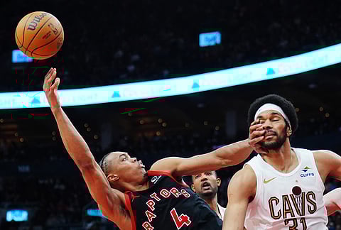 Toronto Raptors' Scottie Barnes (4) tries to shoot over Cleveland Cavaliers' Jarrett Allen (31) during the second half of an NBA playoff basketball game in Toronto.