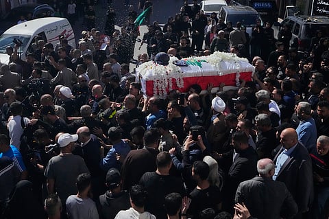Mourners throw flowers and rice over the coffin of Lebanese journalist Amal Khalil, who was killed Wednesday in an Israeli airstrike, during her funeral procession in the village of Baysariyeh in southern Lebanon on Thursday, April 23, 2026.